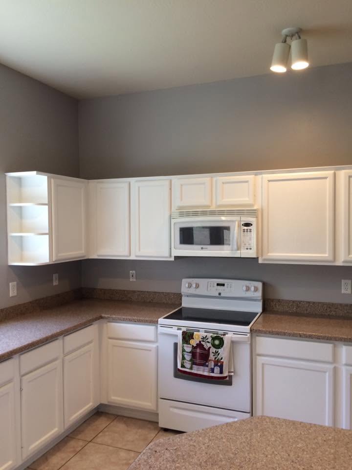 Kitchen cabinets painted white with gray walls by Nieman Painting in Mesa