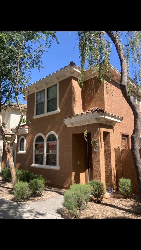 Two-story home with fresh terracotta exterior paint by Nieman Painting
